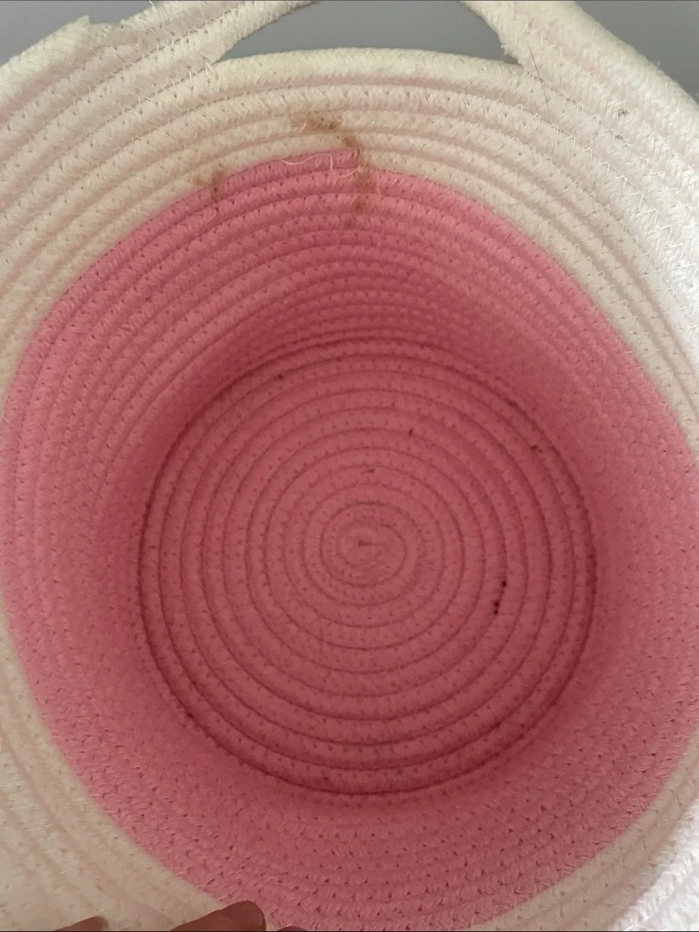 Pink and white braided basket with handles